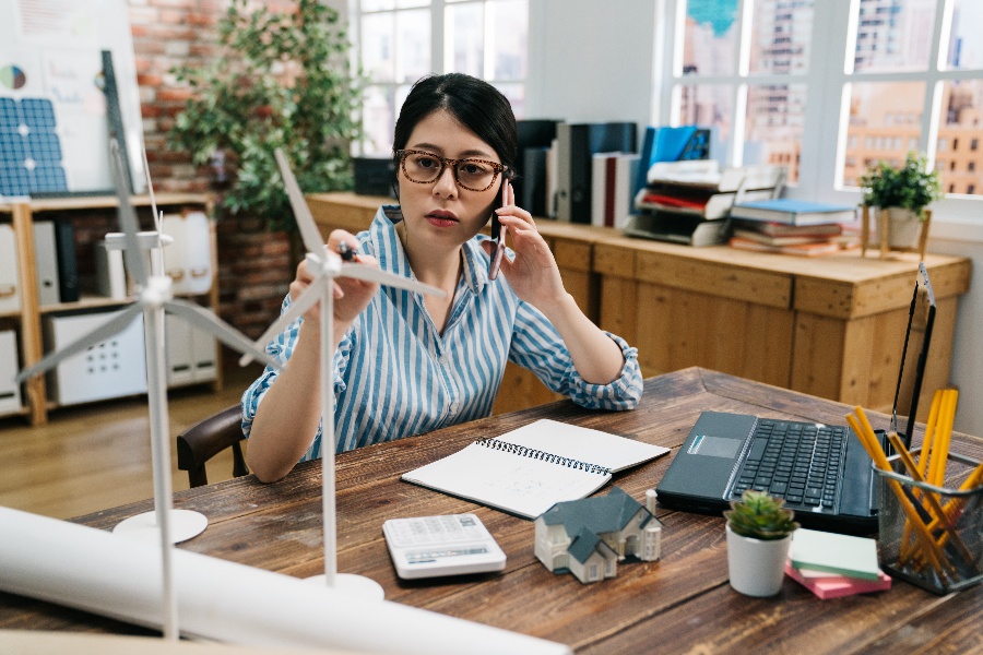 asian woman investing with impact in sustainable energy