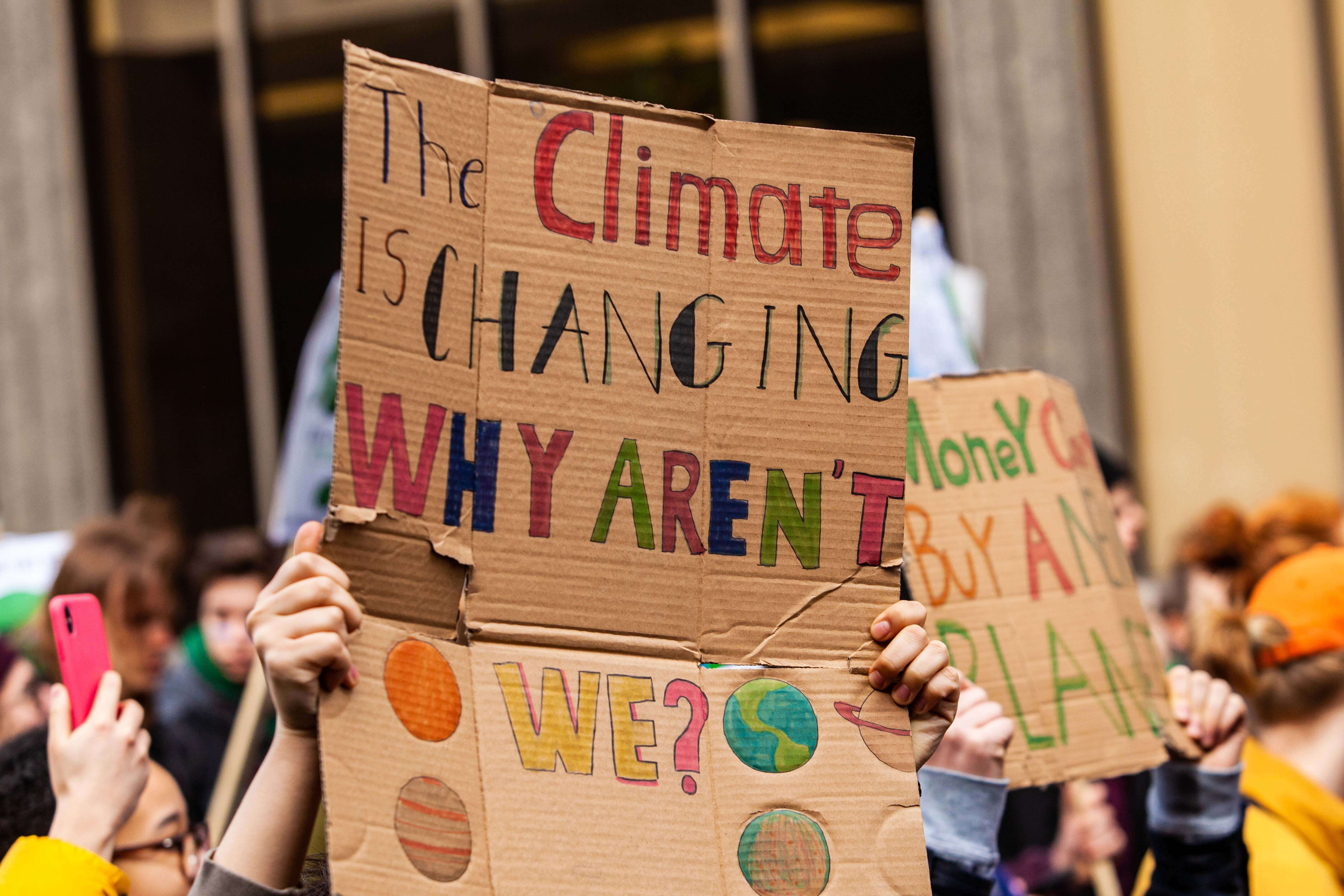A sign at a climate protest directed toward climate deniers that says, 